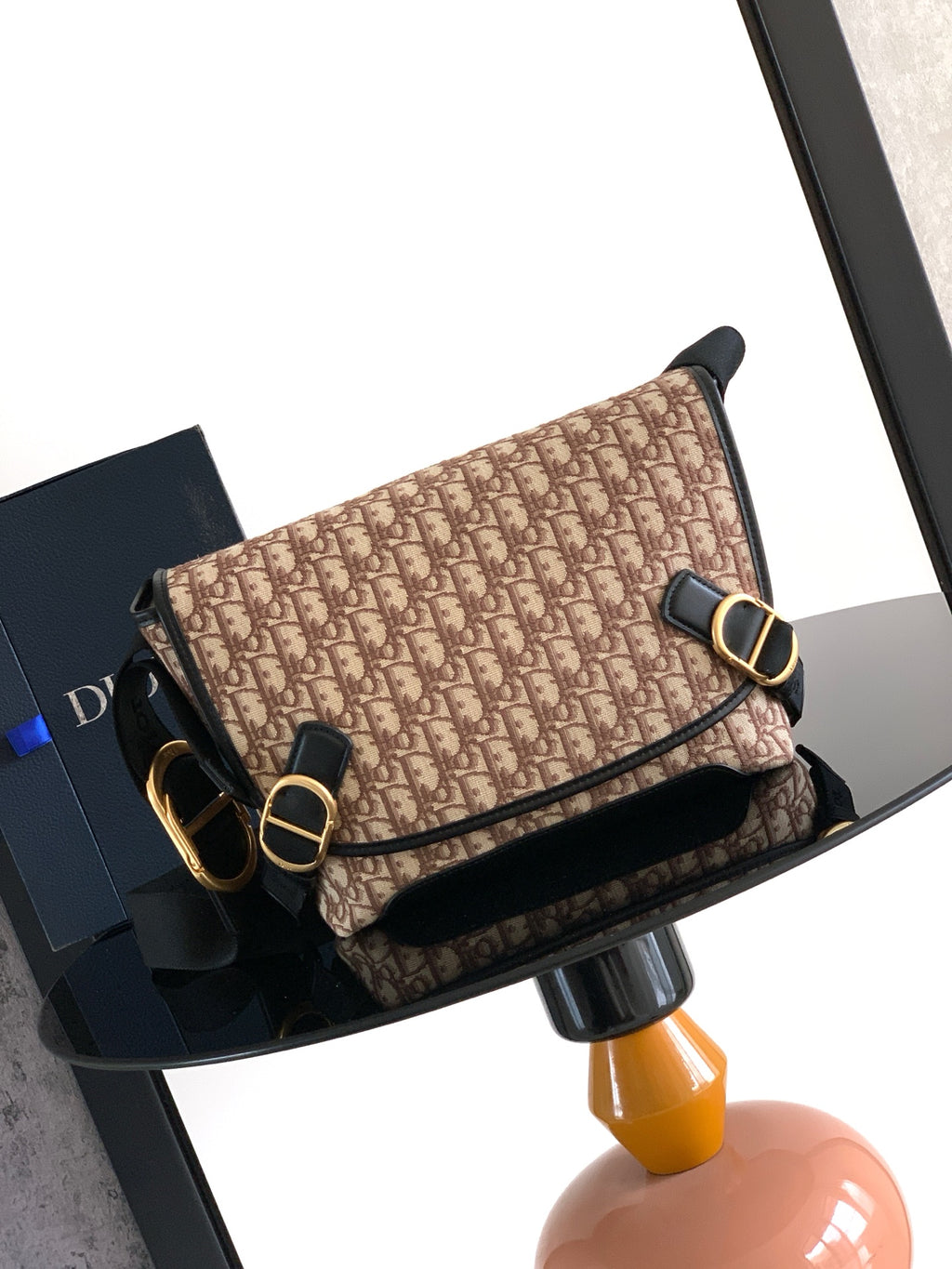 Dior shoulder bag, beige patterned with black trim, gold-tone buckle and strap