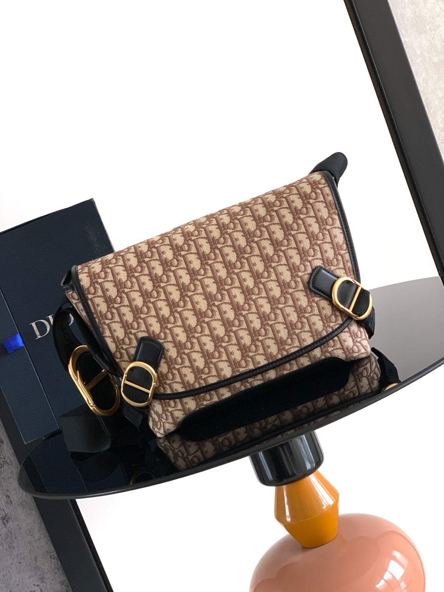 Dior shoulder bag, beige patterned with black trim, gold-tone buckle and strap