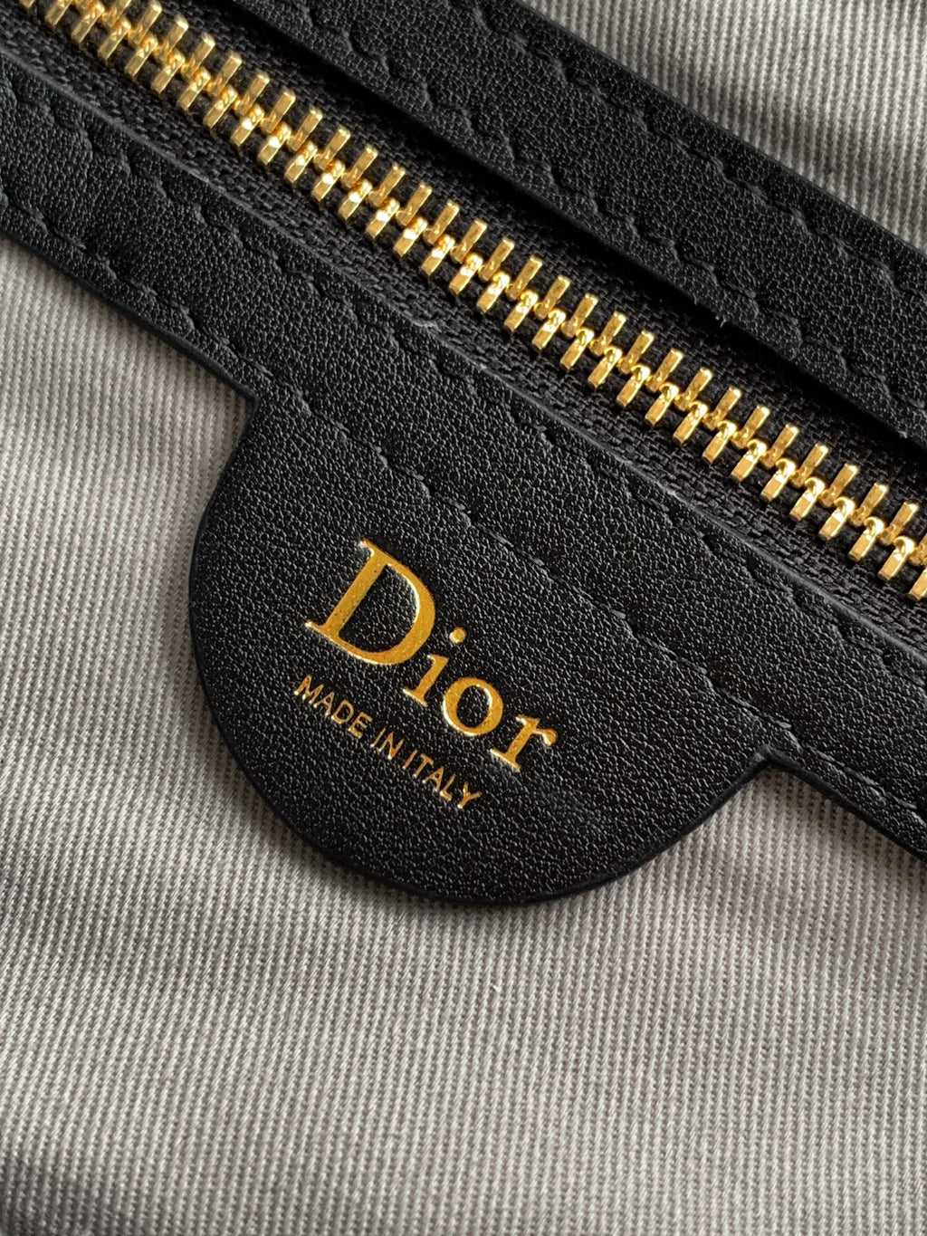 Dior interior pocket detail with gold zipper and Dior leather label