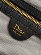 Dior interior pocket detail with gold zipper and Dior leather label