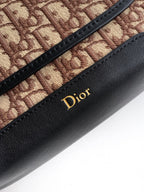 Dior monogram canvas with black leather panel and gold Dior logo