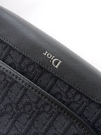 Dior logo detail on textured leather edge, dark