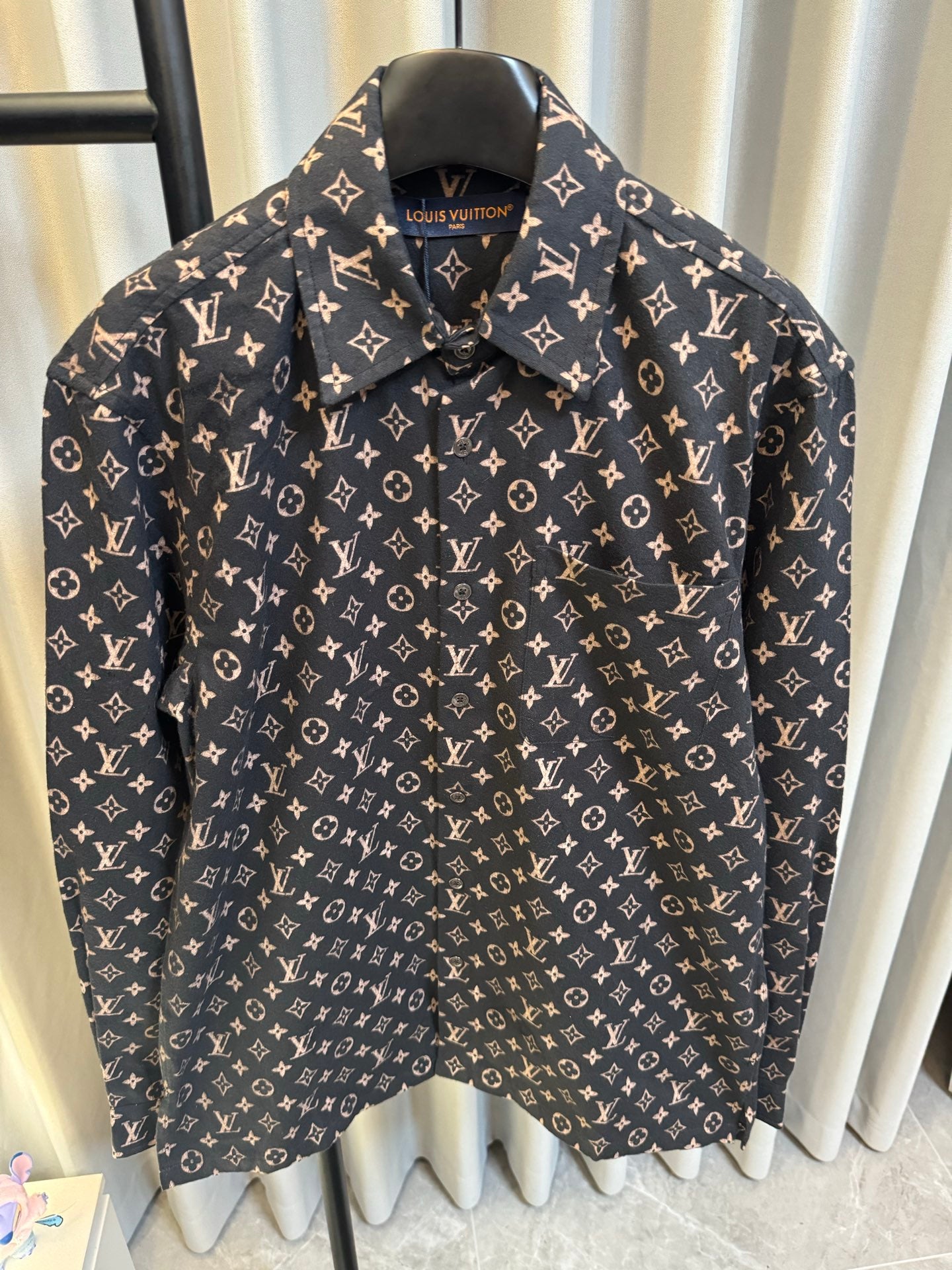 Long-sleeve jacket front close-up in dark navy with Louis Vuitton monogram print, collar