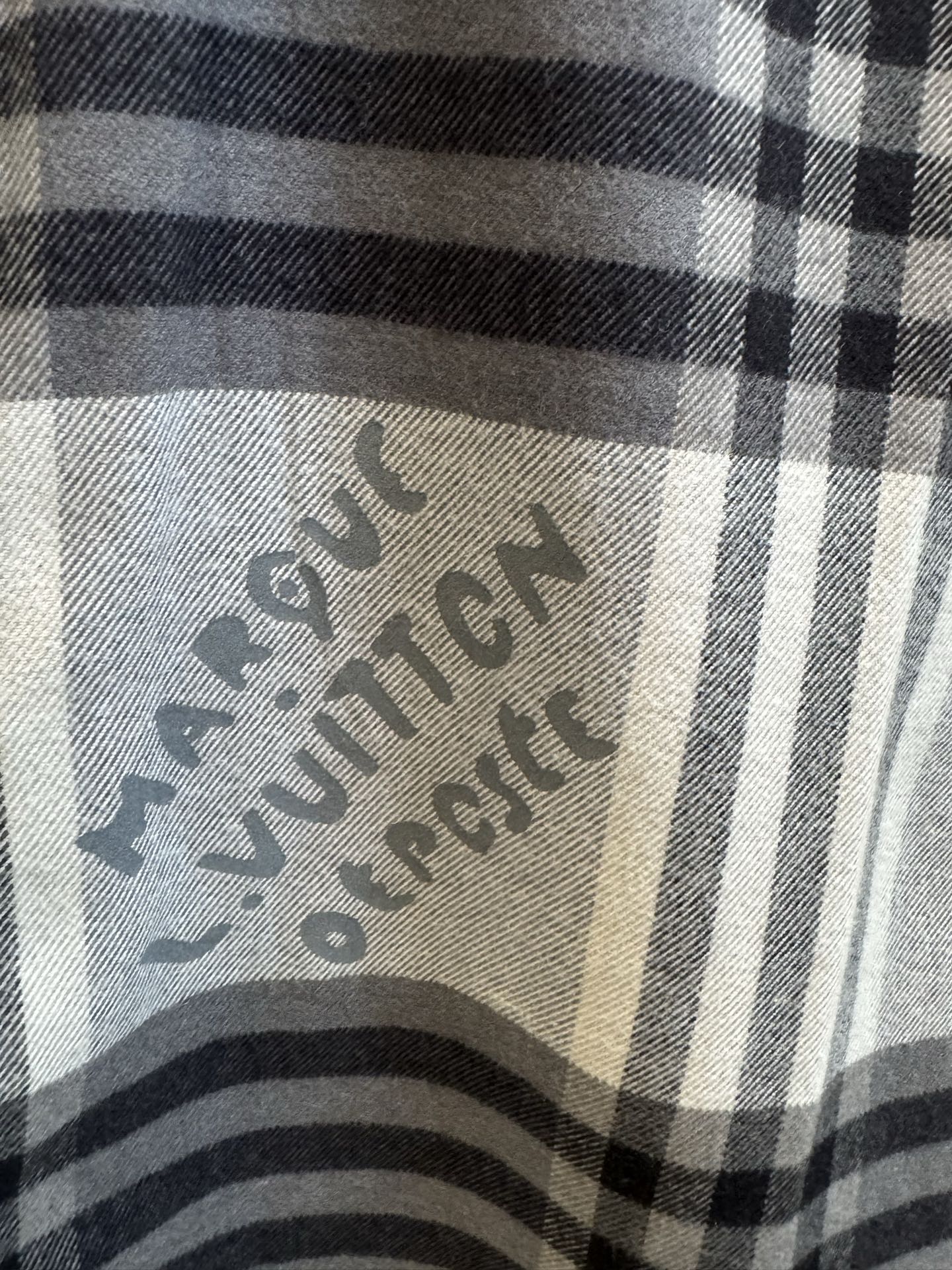 Louis Vuitton plaid fabric close-up with printed logo design