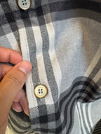 Louis Vuitton plaid shirt close-up of front buttons and stitched placket
