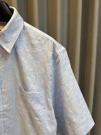 Gucci light blue monogram short-sleeve button-up shirt, side view with chest pocket