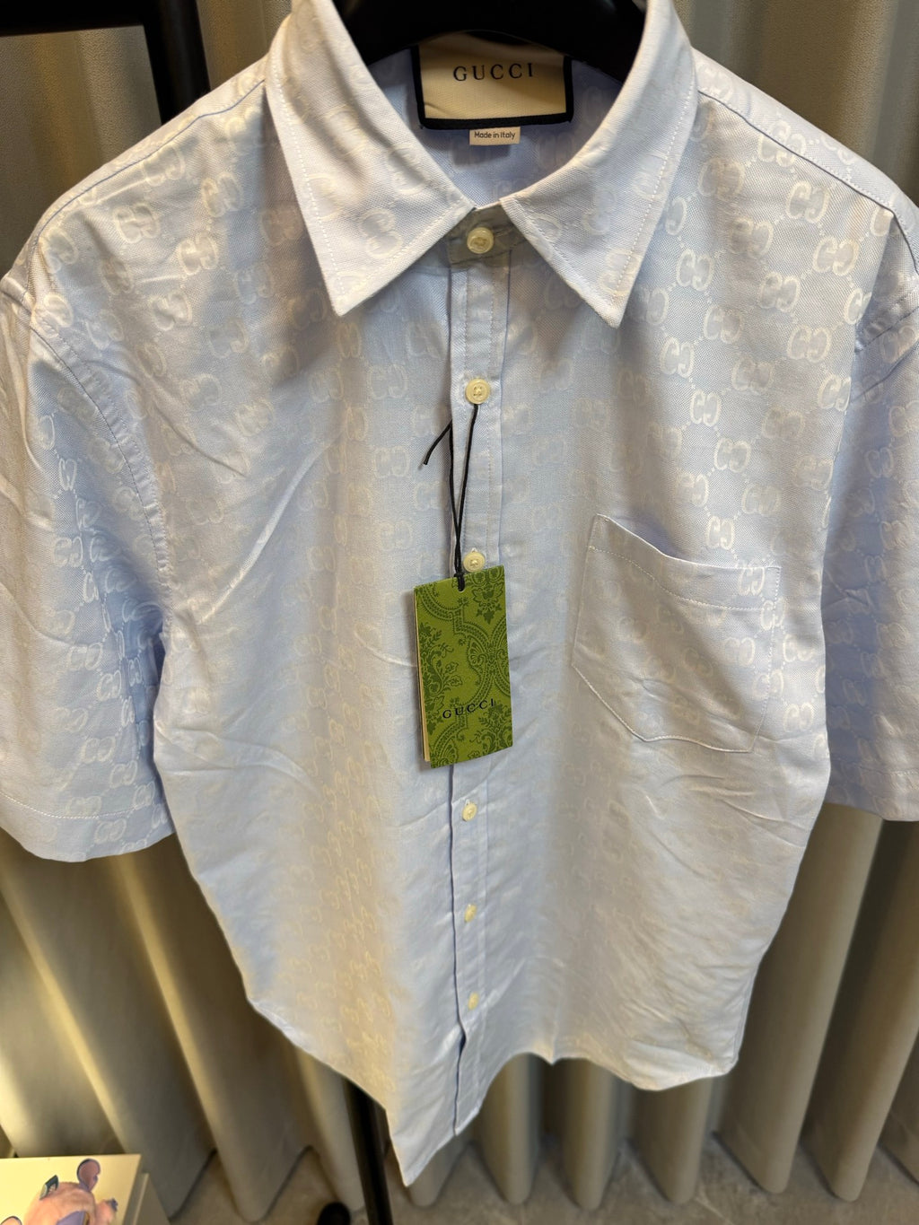 Gucci light blue monogram short-sleeve button-up shirt, close-up of chest buttons