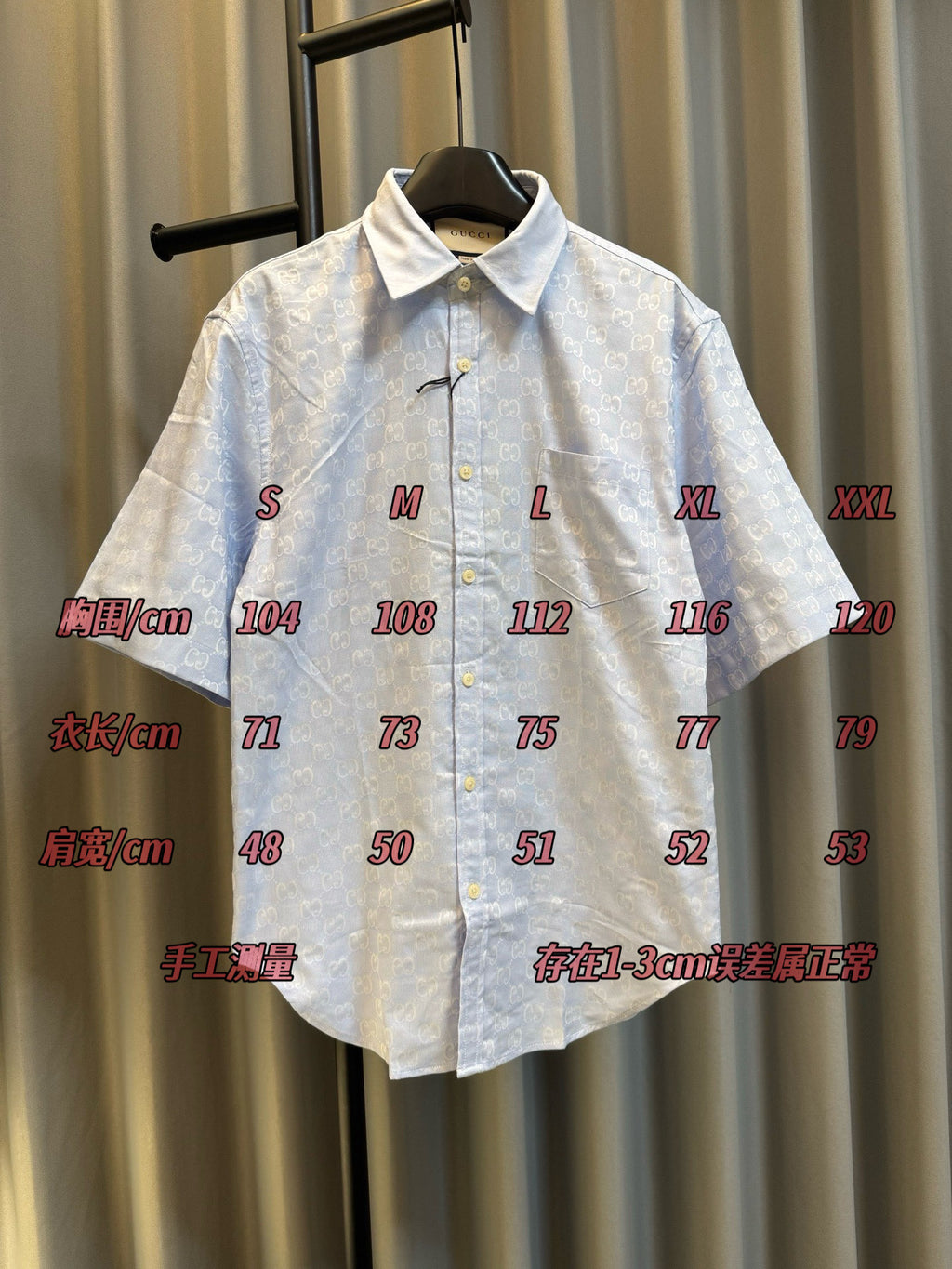 Gucci light blue monogram short-sleeve button-up shirt, front view on hanger