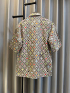 Gucci short-sleeve shirt back view with multicolor logo pattern and green center panel