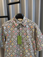 Gucci short-sleeve shirt with multicolor logo print, button placket, and pointed collar