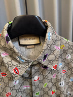 Gucci short-sleeve shirt close-up of collar and tag with multicolor logo pattern