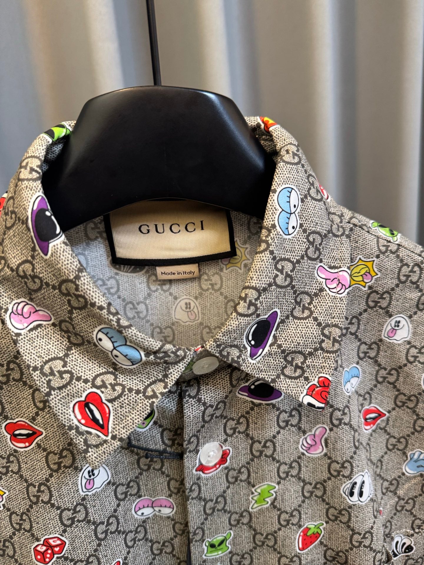 Gucci short-sleeve shirt close-up of collar and tag with multicolor logo pattern