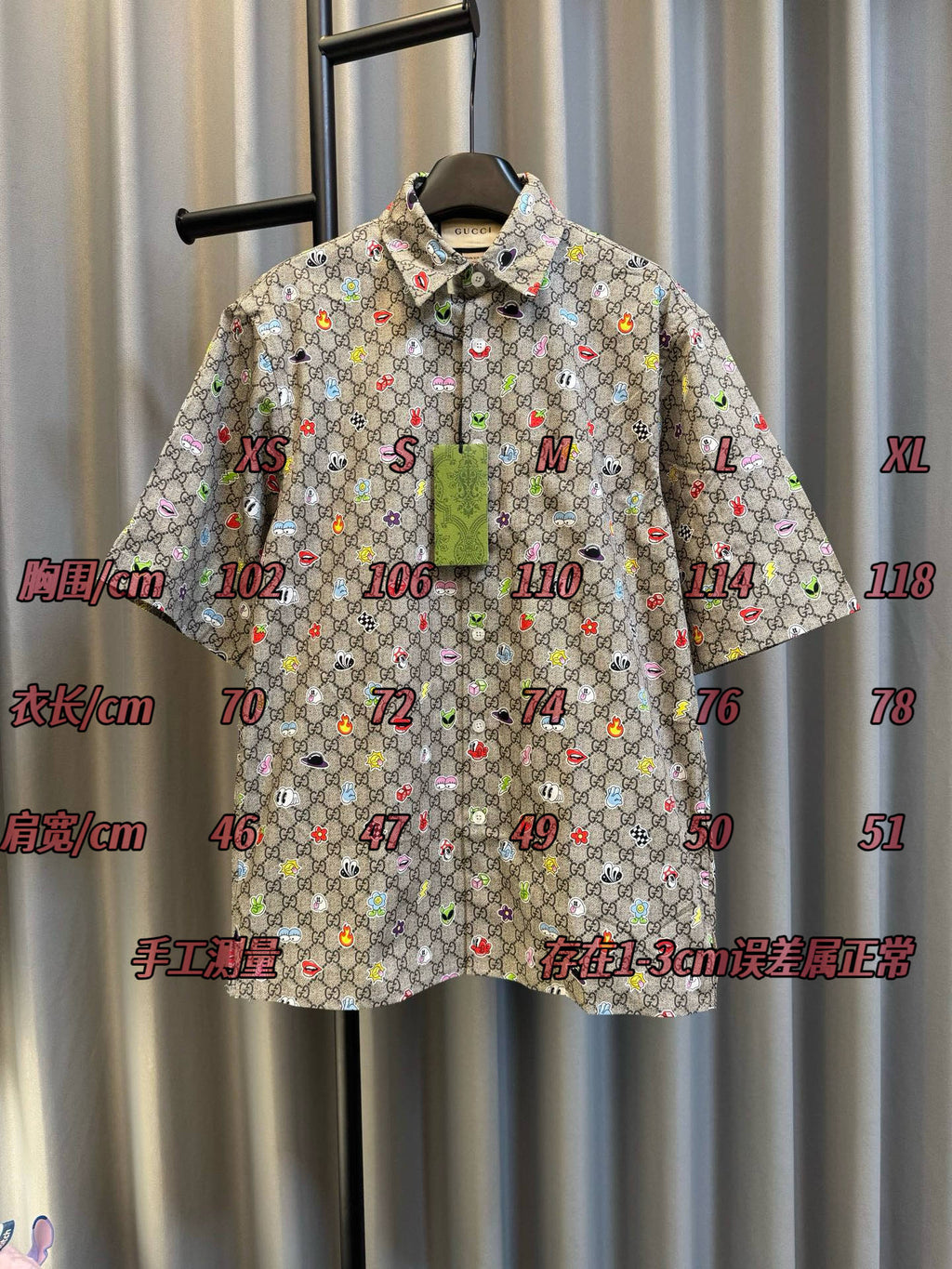 Gucci short-sleeve shirt front with multicolor logo print and size markings on display