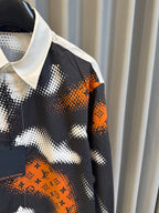 Louis Vuitton long-sleeve shirt sleeve with orange logo print on black camo fabric