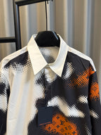 Louis Vuitton long-sleeve shirt with button placket and orange logo patch on camo print