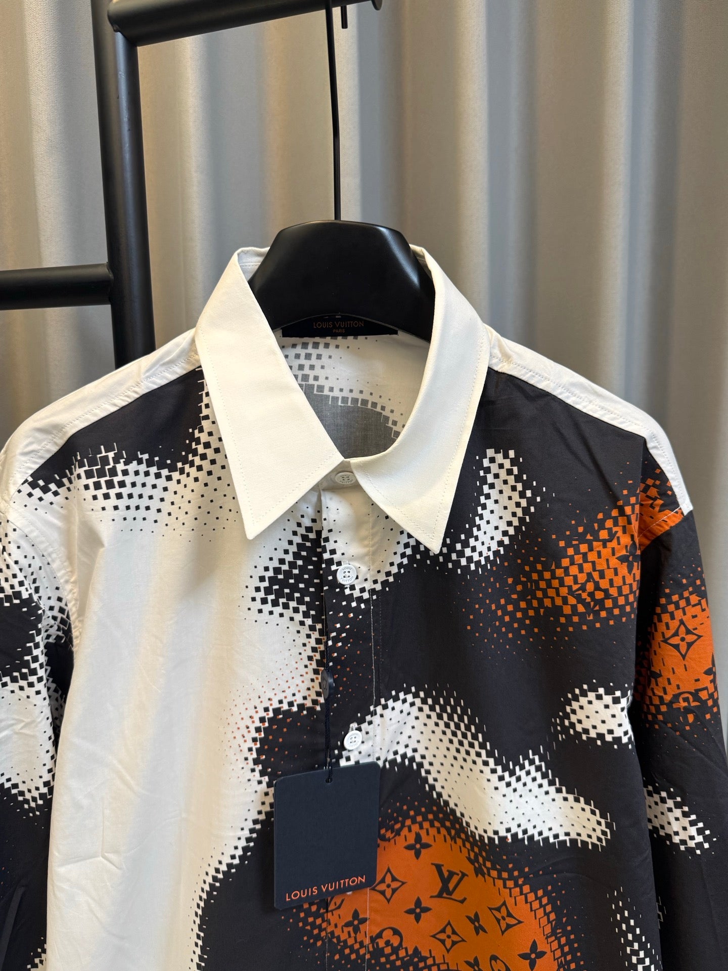 Louis Vuitton long-sleeve shirt with button placket and orange logo patch on camo print