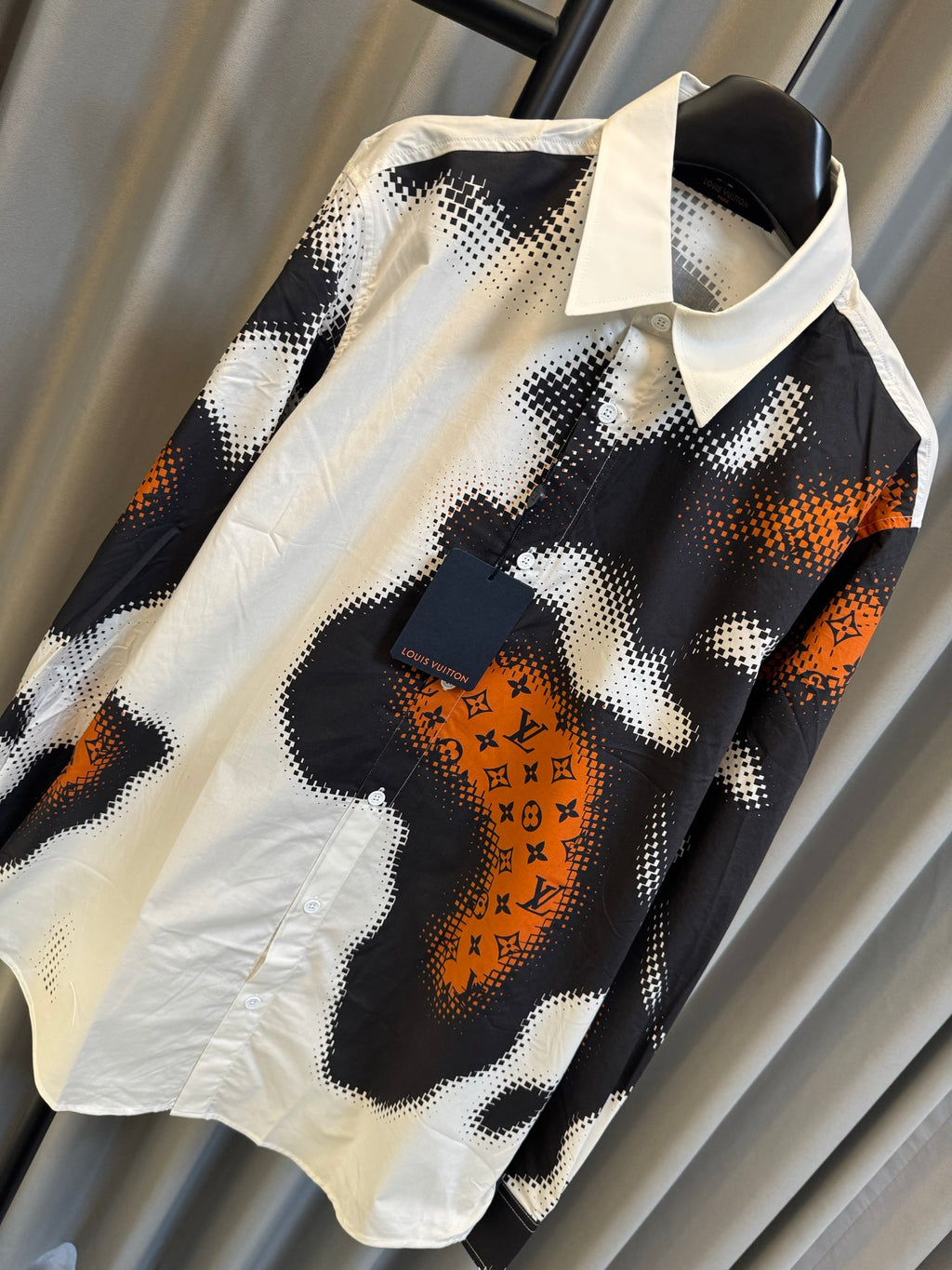 Louis Vuitton long-sleeve shirt with white collar and orange emblem on black camo print
