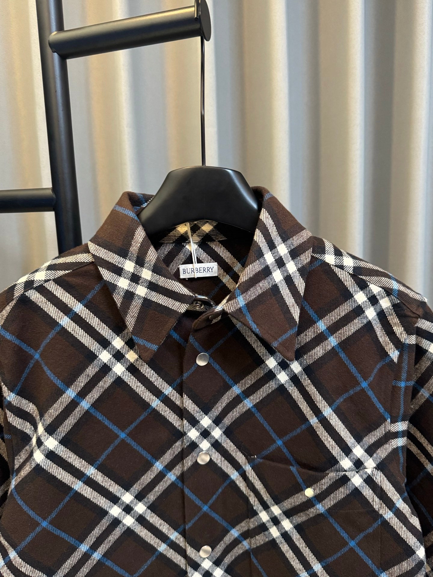 Burberry plaid button-up shirt collar and placket, dark brown with blue and white checks