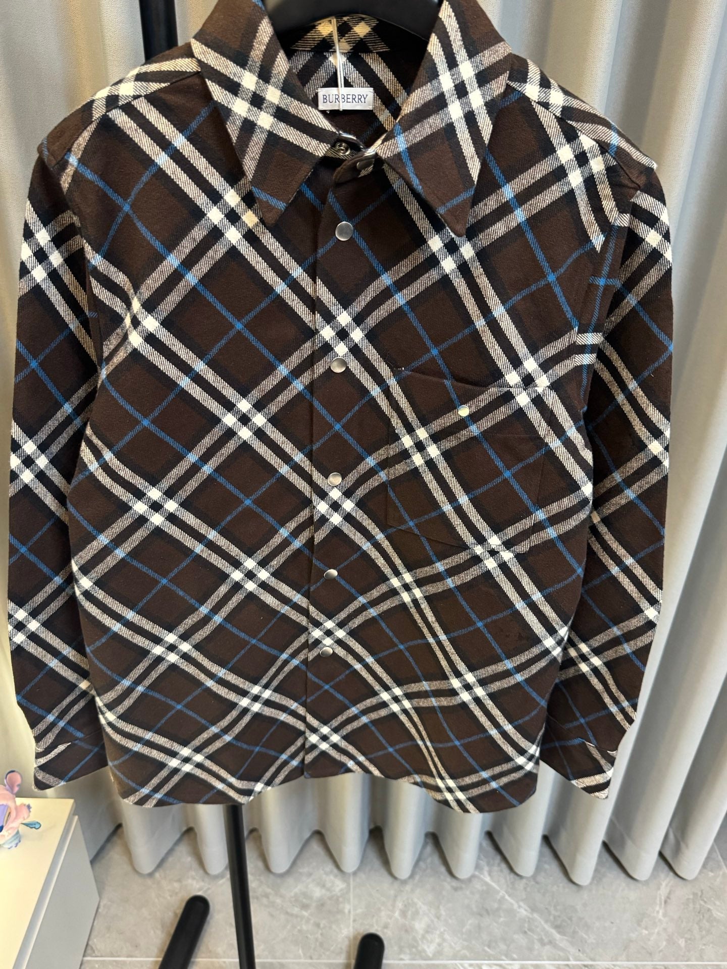 Burberry plaid button-up shirt front, dark brown with blue and white checks