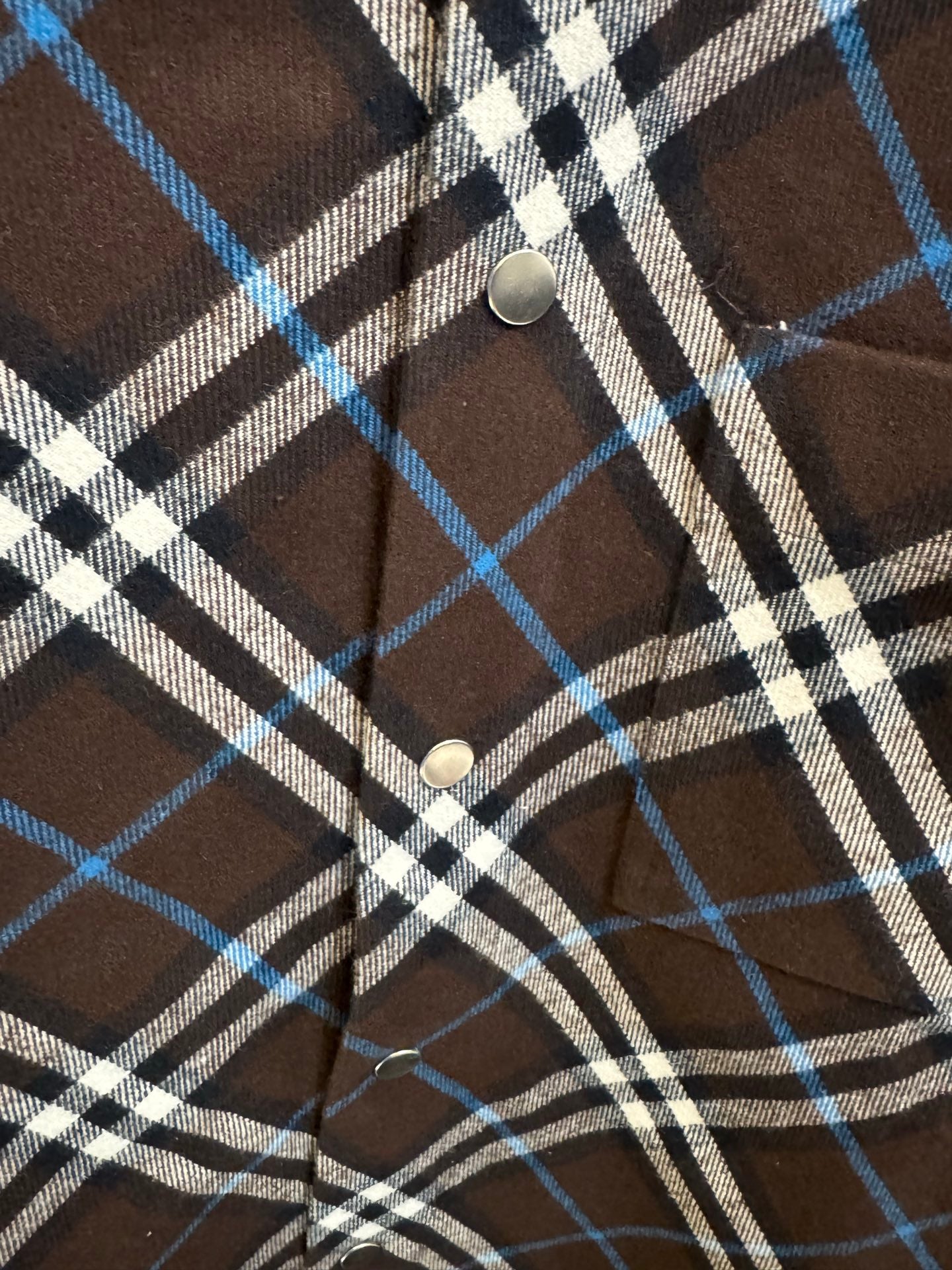 Burberry plaid shirt button detail, dark brown with blue and white check placket