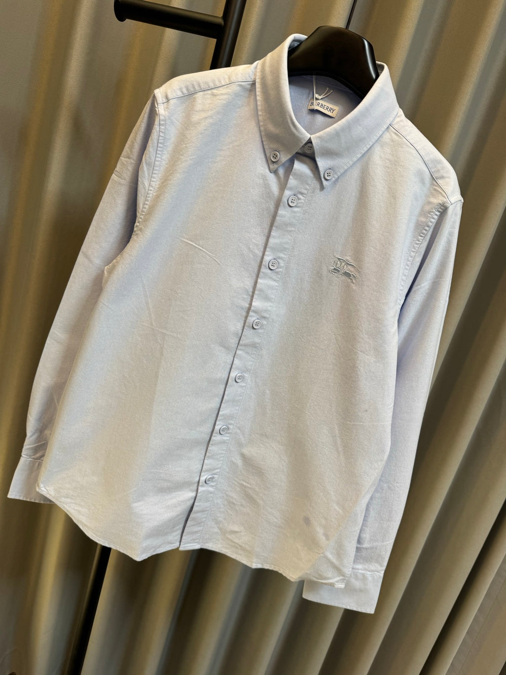 Light blue Burberry button-up shirt with pointed collar and chest logo detail