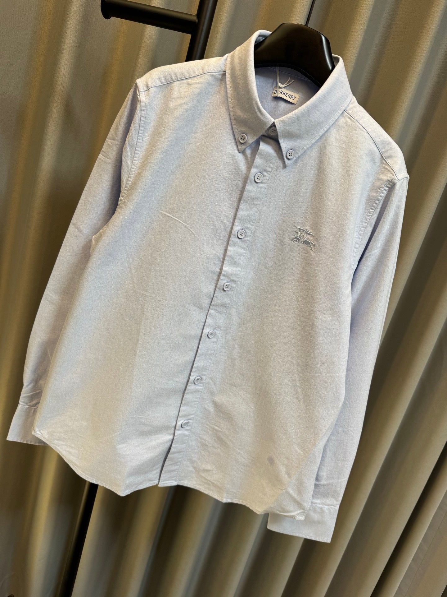 Light blue Burberry button-up shirt with pointed collar and chest logo detail