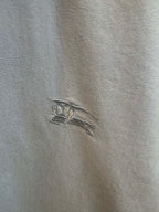 Embroidered horse logo on light blue Burberry shirt fabric