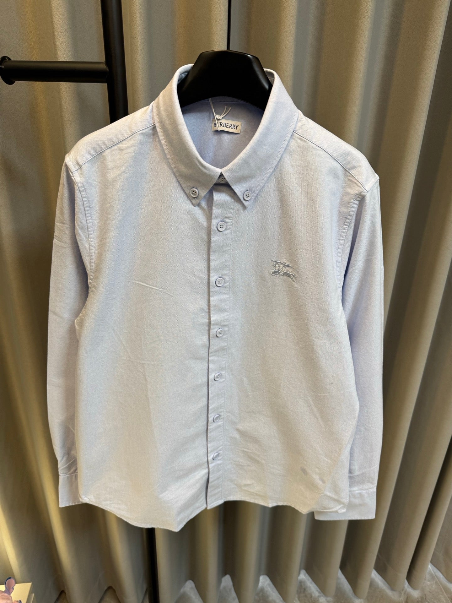 Light blue Burberry button-up shirt with pointed collar and front button placket