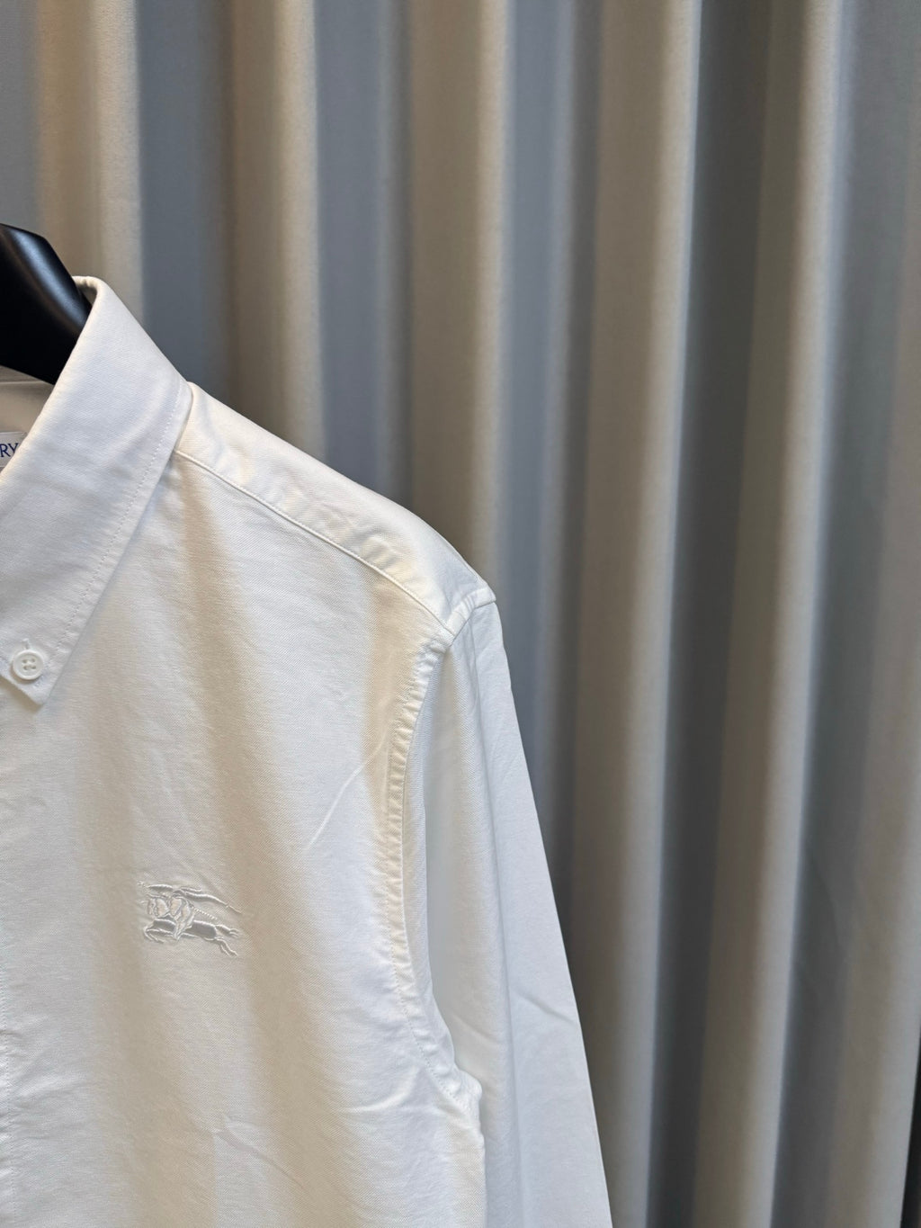 Burberry long-sleeve button-up shirt, white, side view with embroidered chest detail