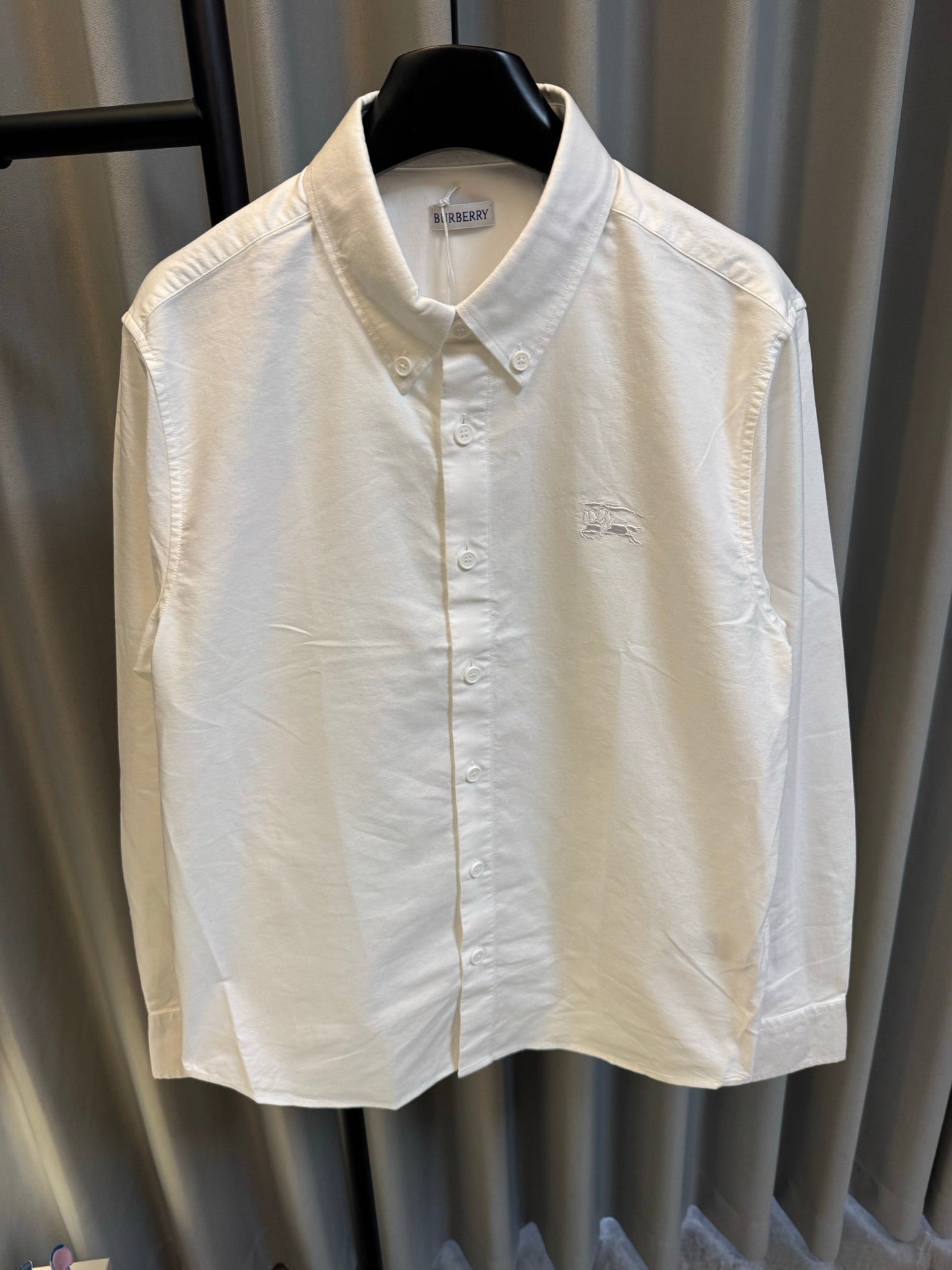 Burberry long-sleeve button-up shirt, white, front view with button placket and collar