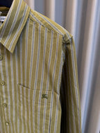Close-up of green striped shirt collar and button placket