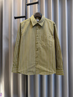 Green striped button-up shirt with point collar on hanger