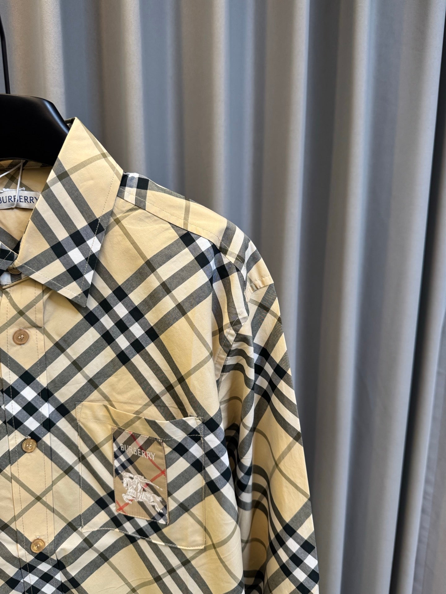 Burberry plaid button-up shirt showing side view with tan base and navy check pattern