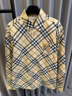 Burberry tan plaid button-up shirt with navy checks, button placket, and embroidered chest patch