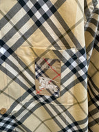 Burberry inside cuff label and logo patch detail on tan and navy plaid shirt