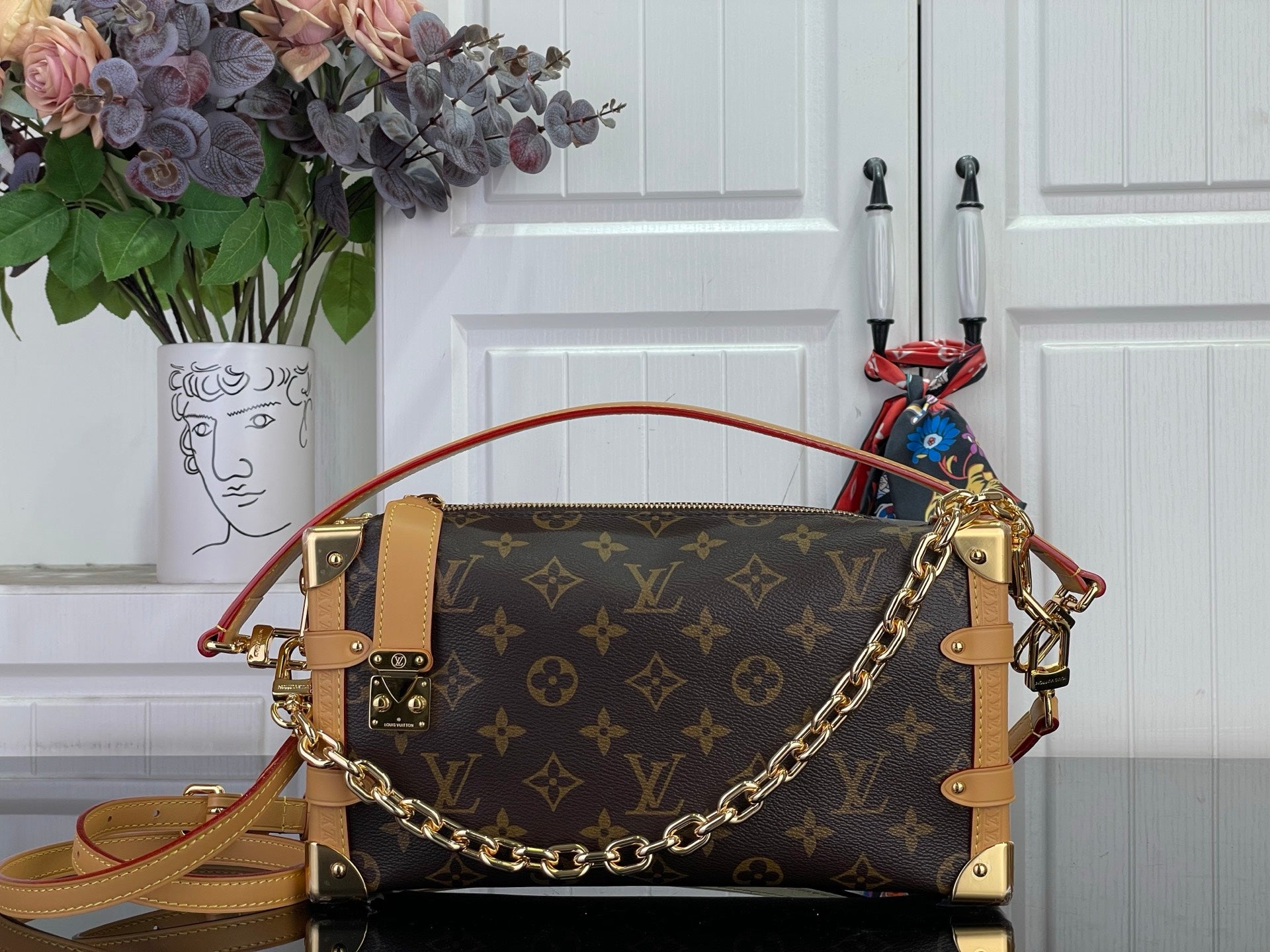 Louis Vuitton monogram handbag with tan leather trim and gold chain shoulder strap