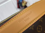 Louis Vuitton monogram bag close-up of tan leather nameplate and gold stitching