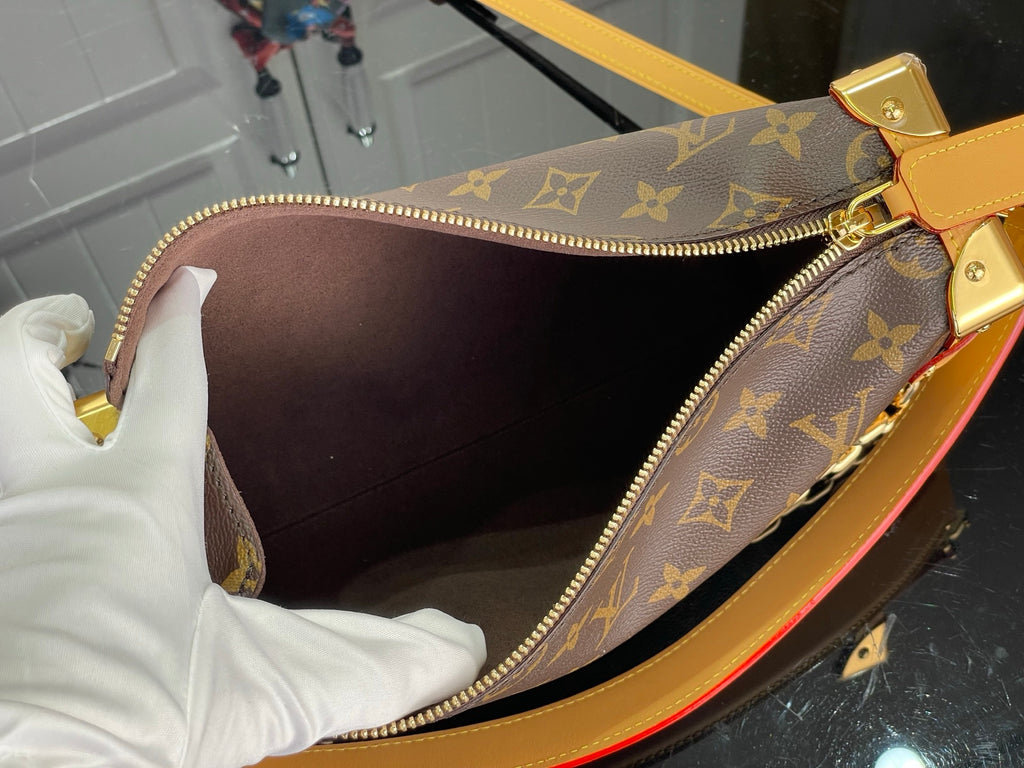 Louis Vuitton monogram handbag interior with dark lining and zippered opening