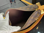 Louis Vuitton monogram handbag interior with dark lining and zippered opening