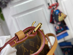 Louis Vuitton monogram bag close-up of burgundy strap and tan leather loop