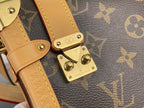 Louis Vuitton monogram bag close-up of gold hardware and tan leather strap