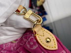 Louis Vuitton leather strap end with gold buckle and stitching on pink monogram bag.
