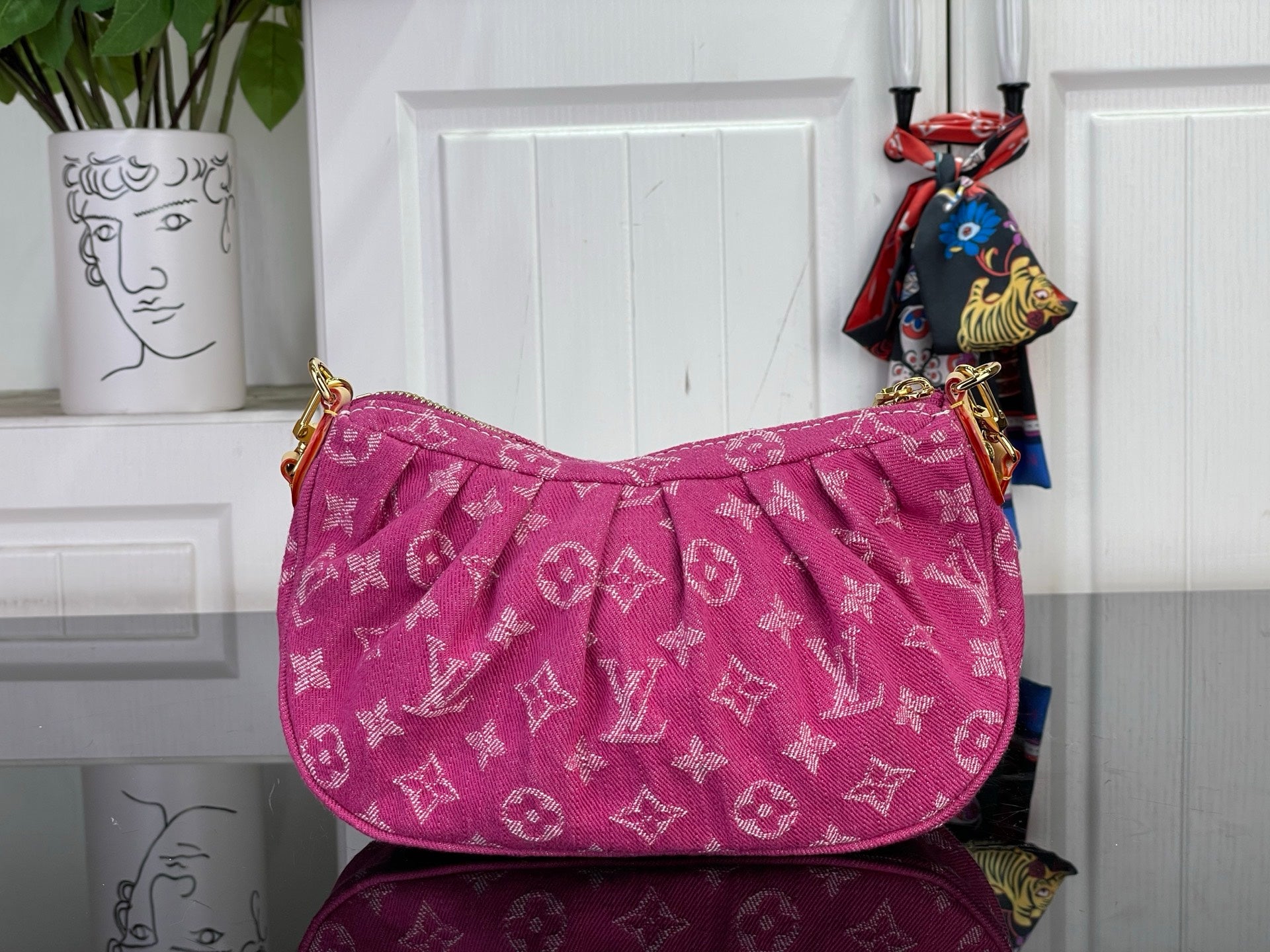 Louis Vuitton pink monogram hobo bag with draped front and gold-tone strap hardware.