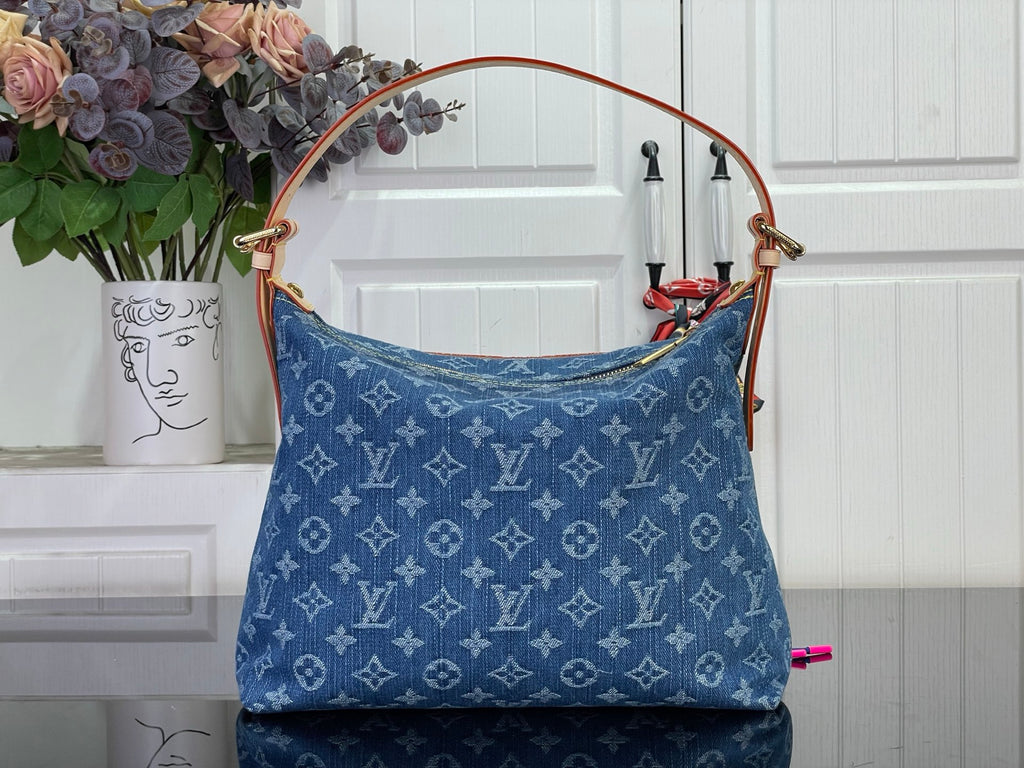 Blue monogram denim handbag with top handles and flap front