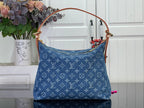 Blue monogram denim handbag with top handles and flap front