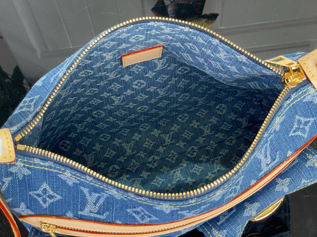 Blue monogram denim handbag interior with gold zipper and tan trim
