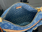 Blue monogram denim handbag interior with gold zipper and tan trim