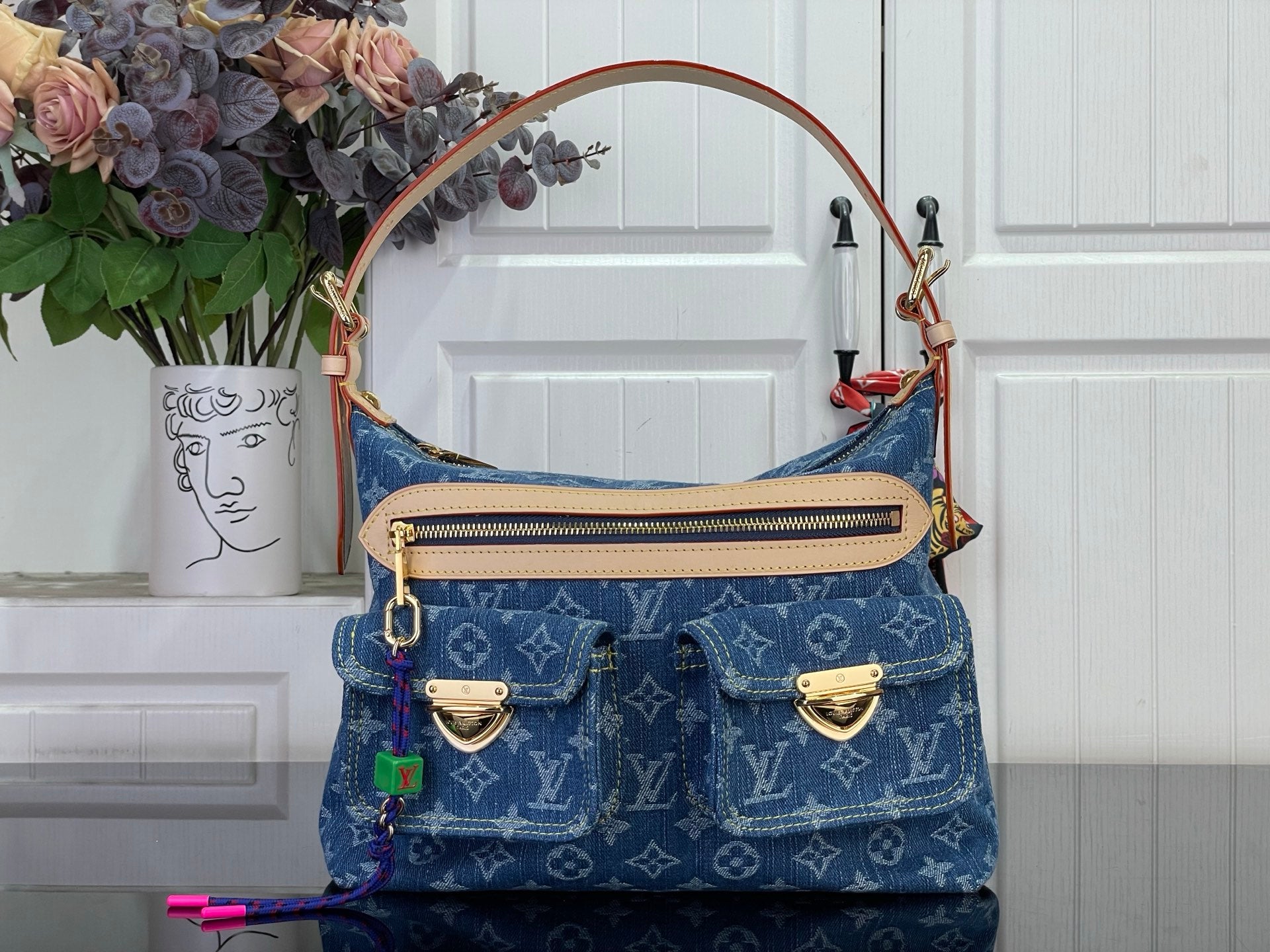 Blue monogram denim handbag with top handles and front flap pocket