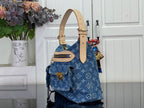 Blue monogram denim handbag with beige shoulder strap and gold hardware