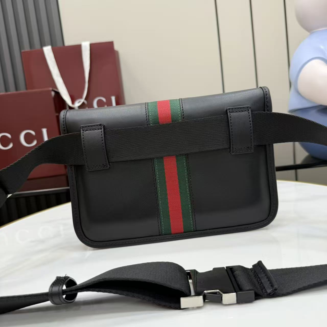 Gucci shoulder bag in dark leather with green-red web stripe, top flap, and adjustable strap